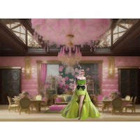 a woman in a green dress is standing in a pink room