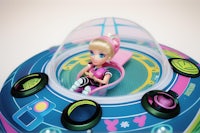 a toy doll is sitting inside a spaceship