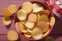 potato chips in a bowl on a wooden table