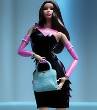 a barbie doll in a black dress holding a blue purse