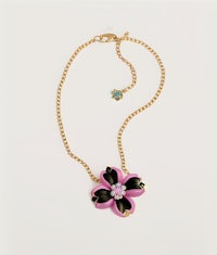a pink and black flower necklace on a gold chain