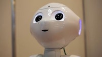 a white robot with big eyes looking at the camera