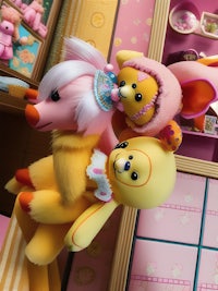 a group of stuffed animals in a pink room